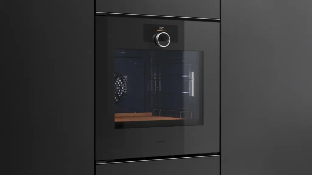 Dunkler, griffloser Gaggenau Backofen der Serie Minimalistic mit zentralem Bedienring in schwarzer Schrankfront